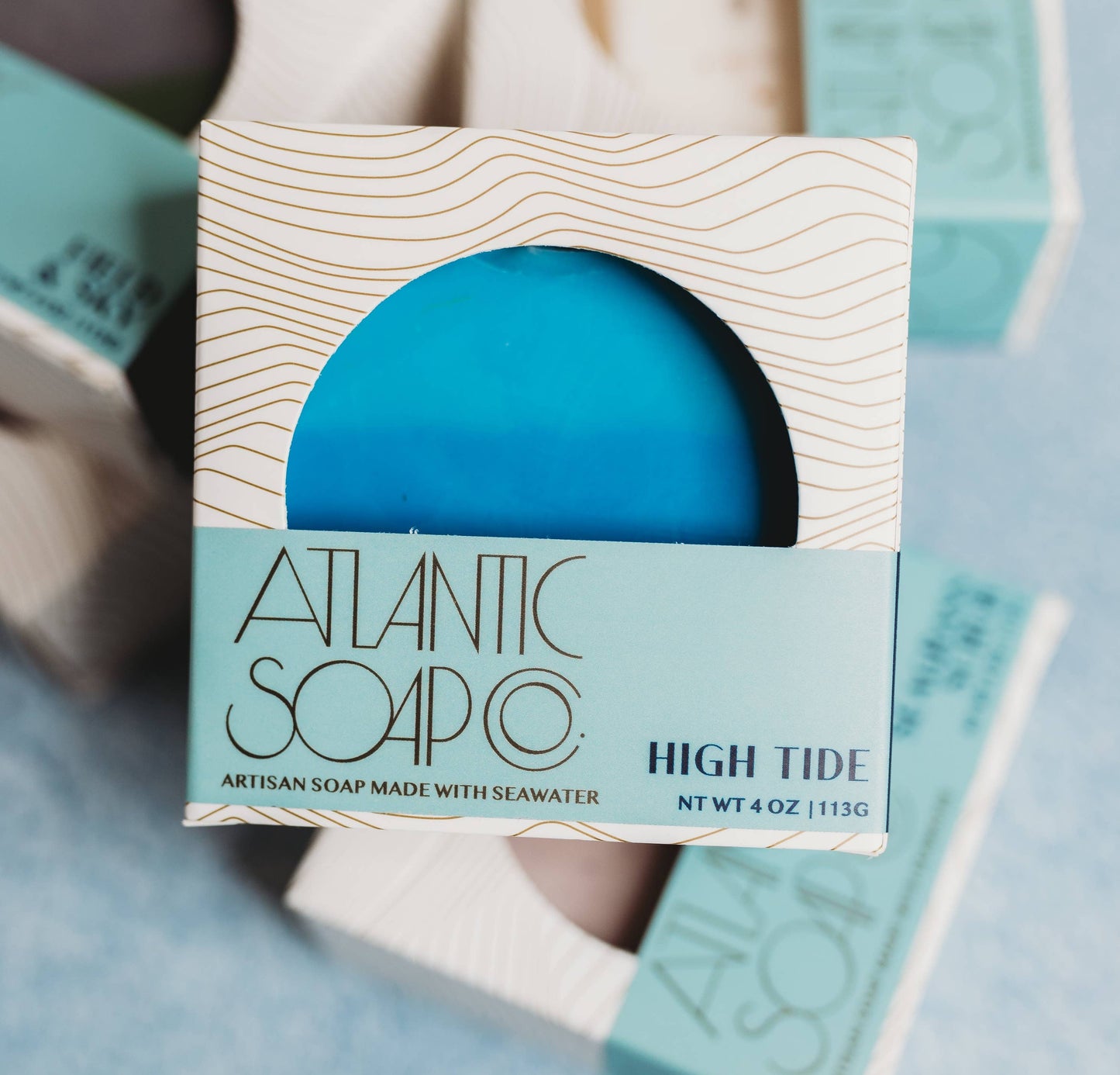 Blue soap bar in a packaging box with 'Atlantic Soap Co' branding on a light blue background.